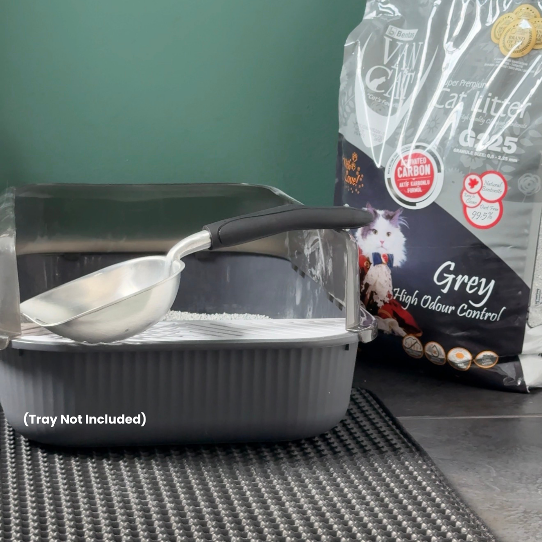Cat litter box with scoop and anti-tracking mat and bag of cat litter on a green background